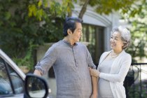 Cheerful senior Chinese couple standing on street — Stock Photo