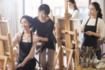 Asian women with art teacher working in studio — Stock Photo