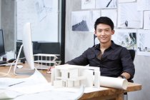 Chinese male architect working in office — Stock Photo