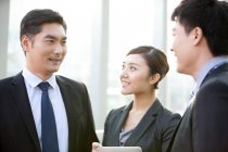 Chinese business people having discussion in office — Stock Photo