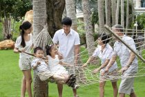 Chinese multi-generation family playing on hammock — Stock Photo