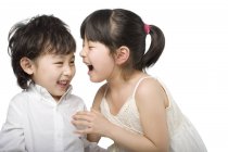 Смеющиеся азиатские дети на белом фоне — стоковое фото