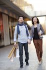 Chinese couple shopping in city downtown — Stock Photo