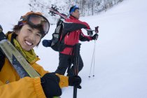 Chinese skiers hiking in snow-capped mountains — Stock Photo