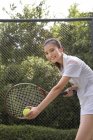 Young Chinese woman playing tennis — Stock Photo
