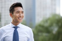 Confident Chinese businessman standing outdoors — Stock Photo
