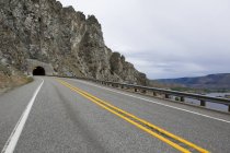 View of highway road through tunnel in rock — Stock Photo