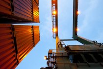 Bottom view of crane and stack of cargo containers — Stock Photo