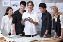 Car designers standing with model car — Stock Photo