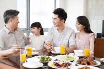 Chinese family with grandfather having dinner together — Stock Photo