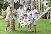 Chinese multi-generation family posing in hammock — Stock Photo