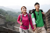 Chinese couple holding hands and looking at view on Great Wall — Stock Photo