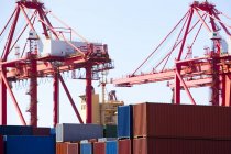 Cranes and cargo containers in shipping dock — Stock Photo