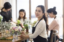 Jovens mulheres chinesas aprendendo arranjo de flores com professor de arte — Fotografia de Stock