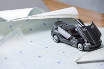 Close-up of model car and blueprints — Stock Photo