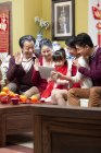 Family using digital tablet for video chatting on Chinese New Year — Stock Photo