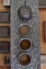 Chinese teapot and tea cups in a row, top view — Stock Photo