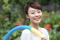 Portrait of Chinese woman with hula hoop — Stock Photo