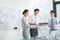 Chinese business team talking on meeting in board room — Stock Photo