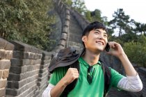 Chinesischer Tourist telefoniert auf großer Mauer — Stockfoto