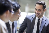 Businessmen and engineers talking at factory — Stock Photo