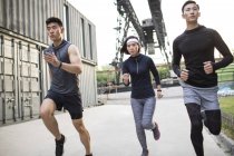 Chinese athletes running at street — Stock Photo