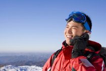 Chinese man in ski gear talking on mobile phone — Stock Photo