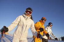 Chinese people posing with ski equipment at slope — Stock Photo