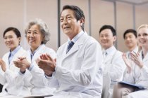 Medical workers clapping on meeting — Stock Photo