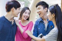 Chinese friends talking together on street — Stock Photo