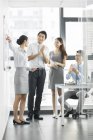 Chinese business people talking at meeting in board room — Stock Photo