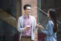 Chinese colleagues talking on street — Stock Photo