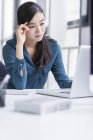 Tired businesswoman working in office — Stock Photo