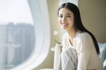 Portrait of Chinese woman sitting in home interior — Stock Photo
