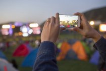 Male hands taking photos with smartphone at music festival — Stock Photo