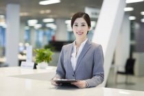 Chinese receptionist at reception counter — Stock Photo