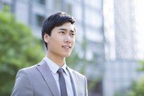 Portrait of chinese businessman looking away — Stock Photo