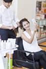 Chinese customer taking selfie in barber shop — Stock Photo