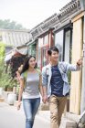 Chinese couple walking on street in Beijing — Stock Photo