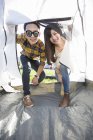 Chinese couple entering tent at festival camping — Stock Photo