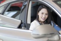 Jeune femme chinoise assise dans la voiture — Photo de stock