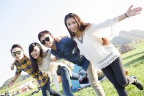 Chinese friends posing at music festival camping — Stock Photo