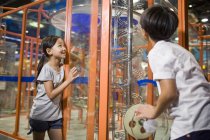 Chinese children looking and interacting at exhibition in museum — Stock Photo