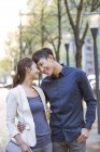 Chinese couple standing face to face on street — Stock Photo