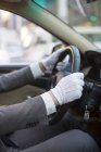 Close-up view of chauffeur hands driving car — Stock Photo