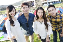 Chinese friends posing at music festival camping — Stock Photo