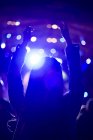 Woman with arms raised at music festival — Stock Photo