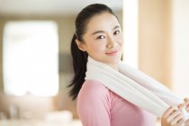 Portrait of Chinese woman with towel around neck — Stock Photo