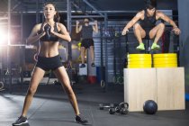 Chinese athletes practicing crossfit at gym — Stock Photo