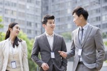 Chinese business people talking on street — Stock Photo
